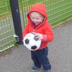 hoodie and a football and a cheeky grin!