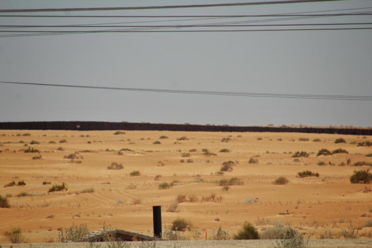 The dark line on the hill is the fence