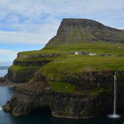 Village where a waterfall tumbles into the ocean