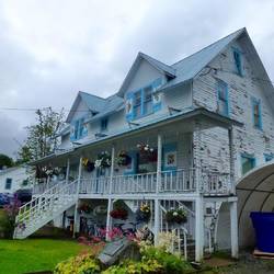 A pretty House with norwegian style shutters.