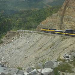The train snakes around the canyon walls.