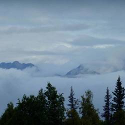 The snow capped peak of Denali can be just seen through the cloud.