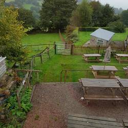 View from Goose and Cookoo Dining room window over Beer garden with camping field beyond