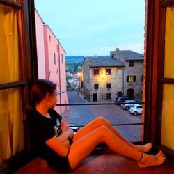 Katie sitting in the window alcove looking out over the square