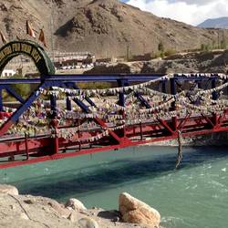Bridge over Indus River with 100s of prayer flags