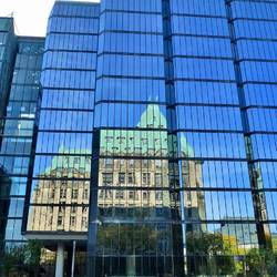 Reflections of Parliament Hill aling Wellington Street