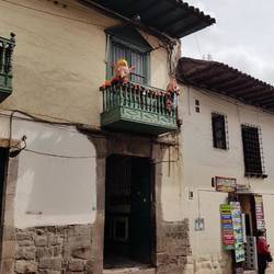 Figurines on the balcony of a house