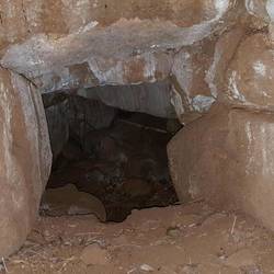 The horizontal hole at the base of the vertical hole