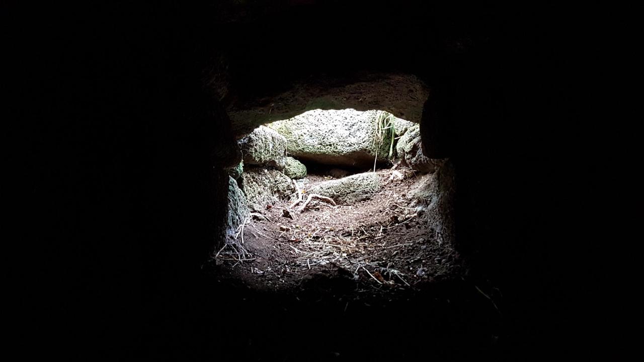 The horizontal hole at the bottom of the vertical hole, from inside the top chamber