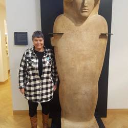 Carol stands next to one of the many statues in the museum.