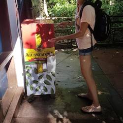 Maria showing the hot water machine where she burnt her hand