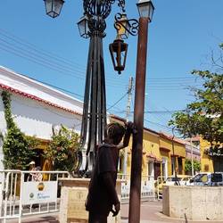 A drunk and a dog pee on a same pole