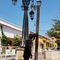 A drunk and a dog pee on a same pole