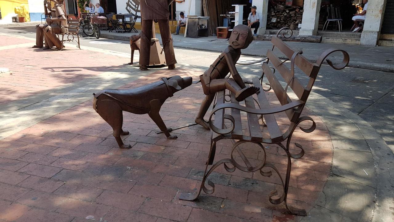 Dog chasing a kid up a bench