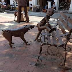 Dog chasing a kid up a bench