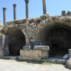Remains of tiny shops under the main roadway of Umm Qais