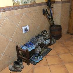 Life on the Camino...poles in the bucket...shoes at the door!