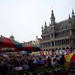 Cafe umbrellas, floats and a Gothic 16th Century King's House.