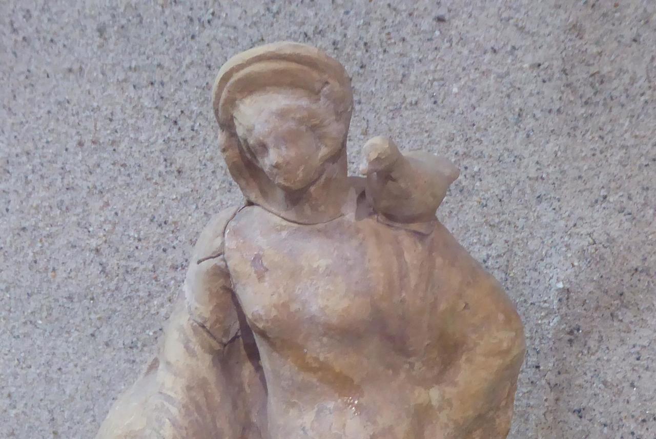 Small statue of a woman who appears to have a duck on her shoulder!