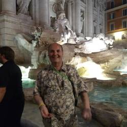 John throwing a coin into the Trevi Fountain.