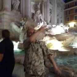 John throwing a coin into theTrevi Fountain