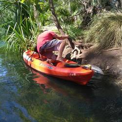 An action shot - a delicate manouvere getting into the kayak