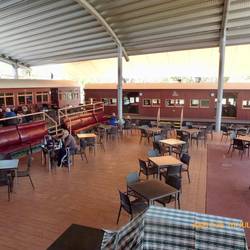 Beautifully restored old railway carriages become dining areas.