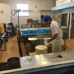 Wrapping the cheese in cheesecloth. Water makes it stick better.