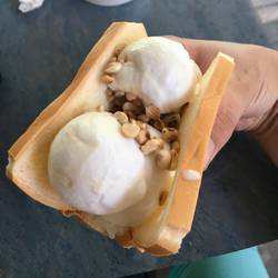 The weirdest and most delicious sandwich ever with bread, icecream, rice, corn and peanuts