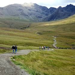 The path people are walking takes you to series of waterfall cascades known as the Fairy Pools.