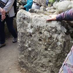 Cup and hook marks.. Archeologists are not sure what these are from.