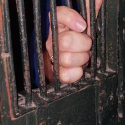 John tries his hand at being held captive in the cells.