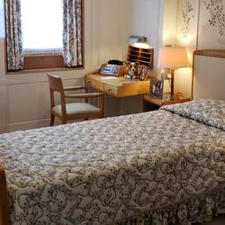 The Queen's bedroom. Prince Philip has a separate room across the corridor. Both have single beds.