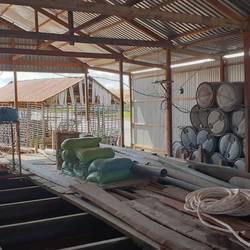 The fish farm is under a large roof.