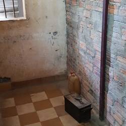 Cell for male prisoner made of brick walls.