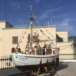 Miniture dive boat outside Church of St Nicholas