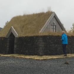 Les photographing a replica of a traditional icelandic house of years gone by.