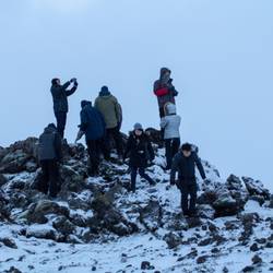 Oriental Tourists Climbing a Lava Formation