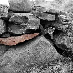 Red rock in sheep pen wall, Djupavik.