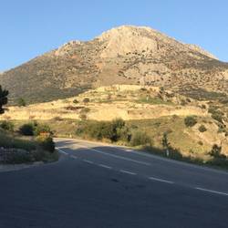 Mycenae on its hill, Lion gate to the left, beehive tomb bottom left outside walls