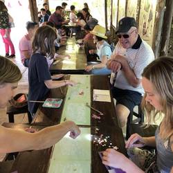 Grandfather with the kids decorating the poopoo paper