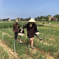 Here she is learning to use traditional watering cans. Try to ignore the sprinklers all around😁.