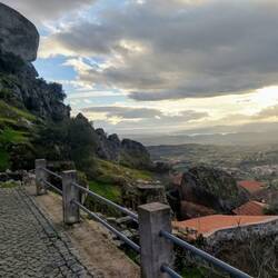 Rocks balancing high above houses