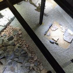 Looking through a glass floor to a kitchen fire pit