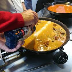 Pouring in the paella rice