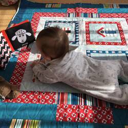Edward tries his new floor quilt from Grandma.