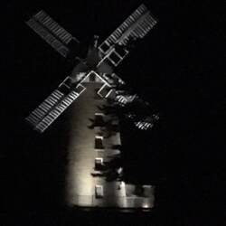 The windmill lit up at night