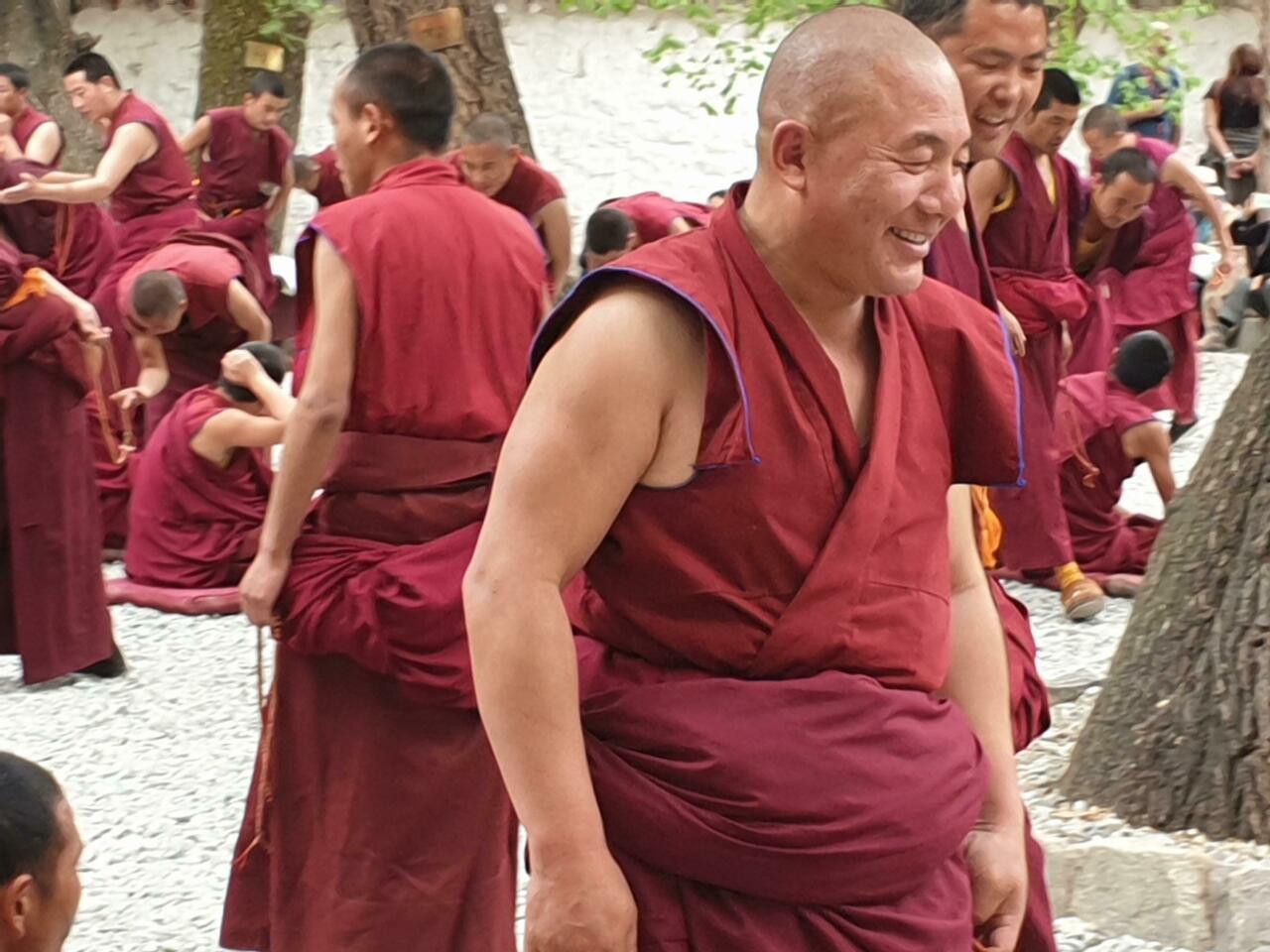 Monks gather in a peaceful courtyard to exchange their views.