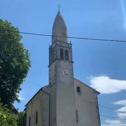 The 15th century St. Daniel's Church in Stanjel. The spire is shaped like a Bishop's hat.