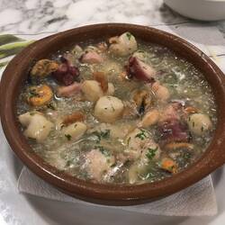 Seafood casserole: scallops, octopus, shrimp and mussels in garlic butter